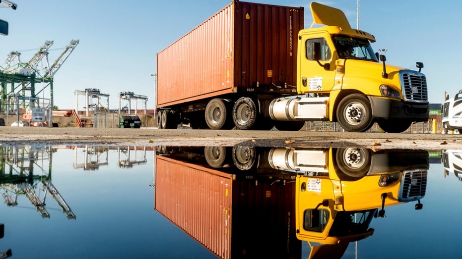 A truck departs from a Port of Oakland shipping terminal