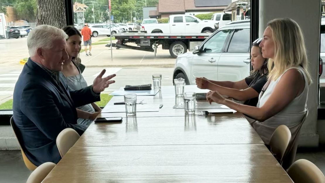 John King sits with Iowa voter Betsy Sarcone and her family in West Des Moines, Iowa.